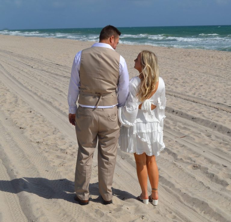 Groom kisses bride at Wedding Day Romance in Pinecrest Florida Bride & groom together, with groom giving a kiss on the cheek to his bride in Miami Florida
